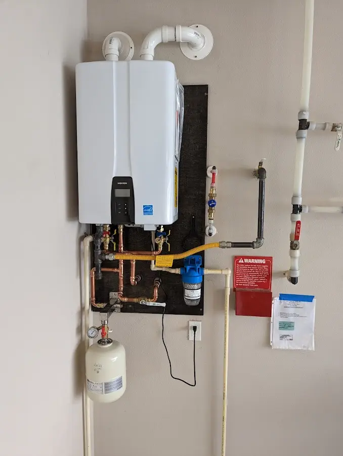 Professional plumber installing copper piping in a Rockland home